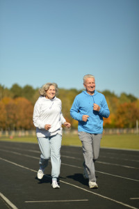 elderly couple running